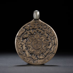 A TIBETAN BRONZE AMULET PLAQUE