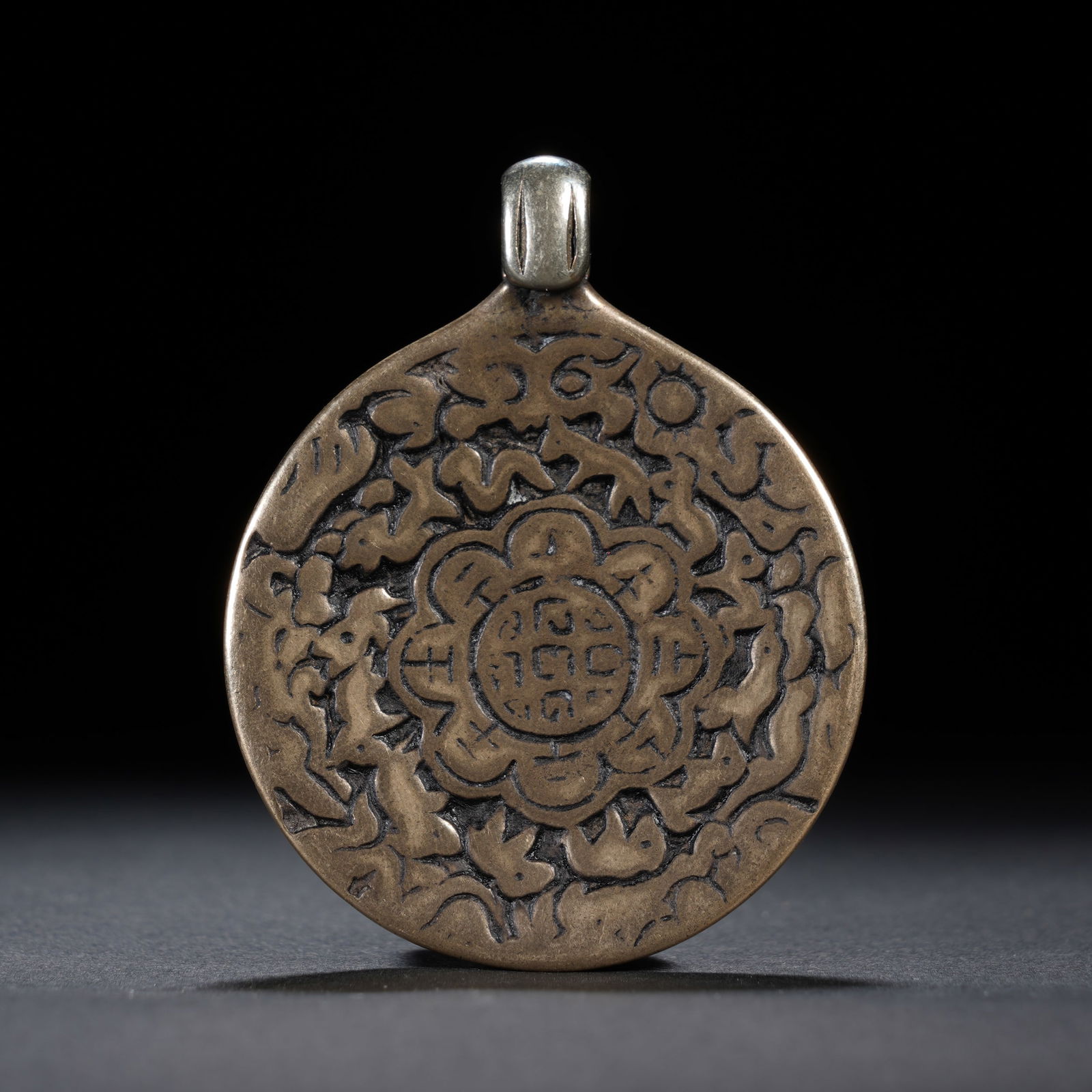 A TIBETAN BRONZE AMULET PLAQUE (1 of 6)