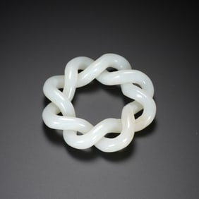 A CARVED WHITE JADE TWIST PENDANT