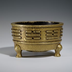 A BRONZE-GILT TRIPOD CENSER