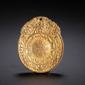 A TIBETAN BRONZE-GILT AMULET PLAQUE