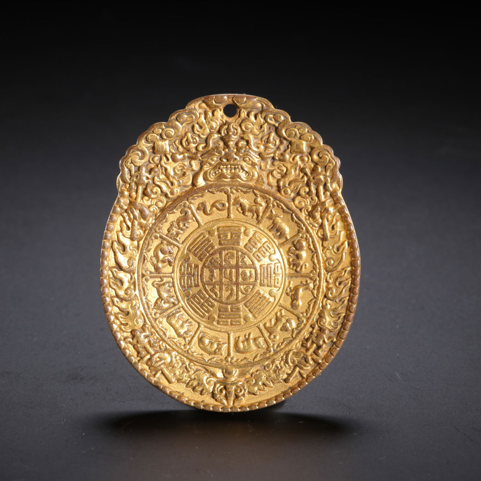 A TIBETAN BRONZE-GILT AMULET PLAQUE (1 of 9)