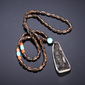 A CARVED ALOESWOOD CHENXIANG GUANYIN PENDANT