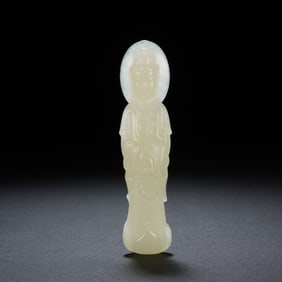 A CARVED WHITE JADE STANDING GUANYIN