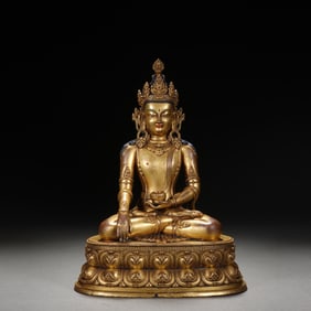 A SINO-TIBETAN BRONZE-GILT FIGURE OF SHAKYAMUNI
