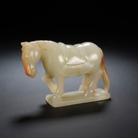A CARVED WHITE JADE HORSE