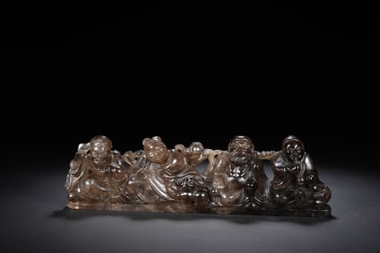 A CARVED SMOKY QUARTZ BRUSHREST