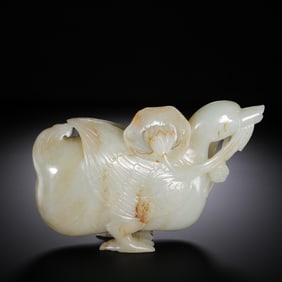 A CARVED WHITE JADE GOOSE WITH LOTUS