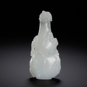 A CARVED WHITE JADE SNUFF BOTTLE WITH COVER