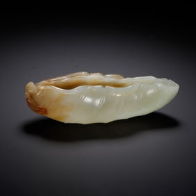 A CARVED WHITE JADE LEAF-FORM WASHER