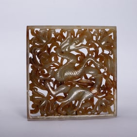 A CARVED WHITE JADE DRAGON PLAQUE