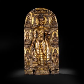 AN IMPORTANT BRONZE-GILT STANDING BUDDHA
