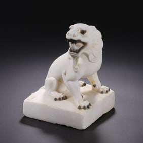 A CARVED MARBLE FELINE