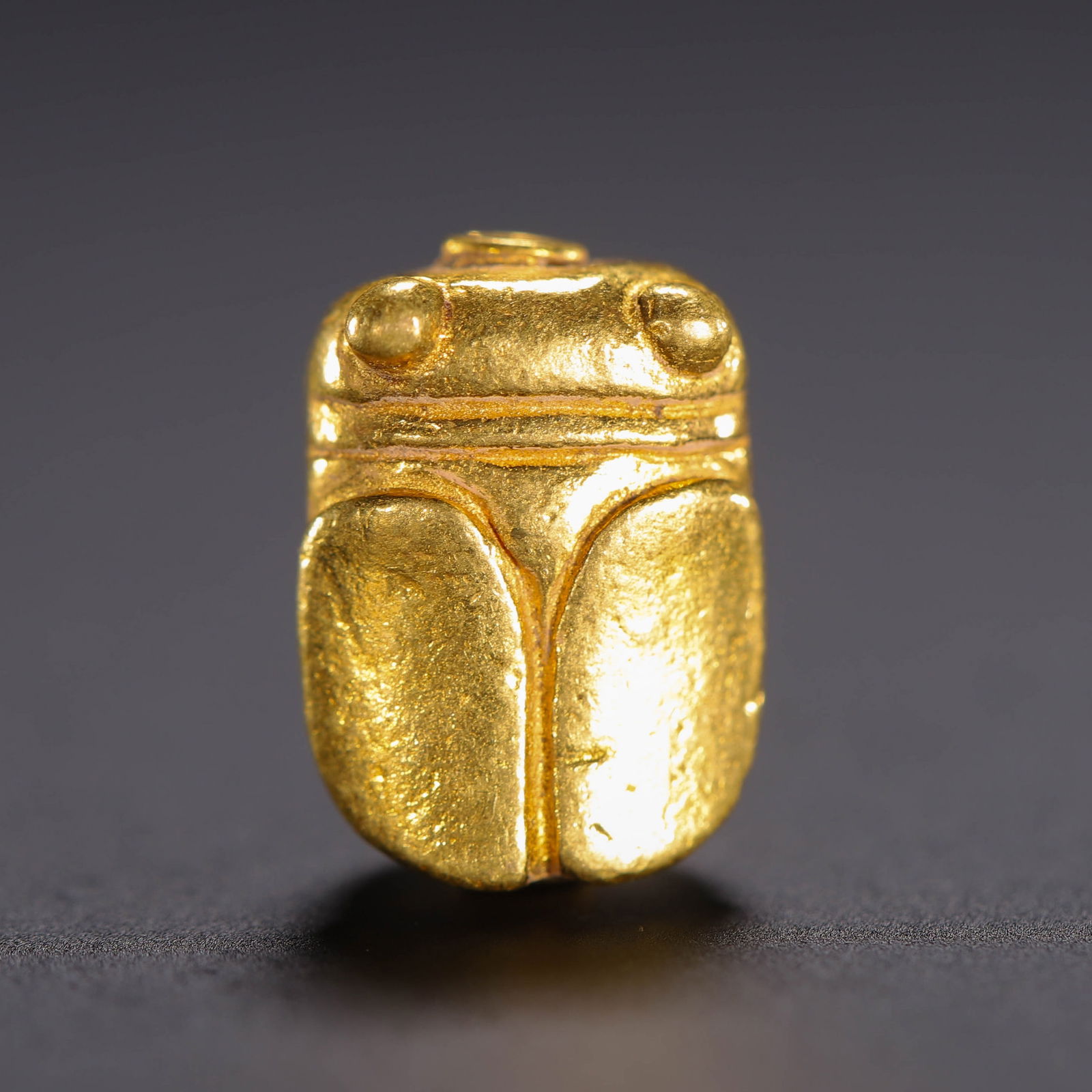 A GOLD CICADA: A GOLD CICADA Casted in cicada form. Dimension: L. 1.2 cm. W. 0.8 cm. H. 0.7 cm. Weight 4.3 grams.