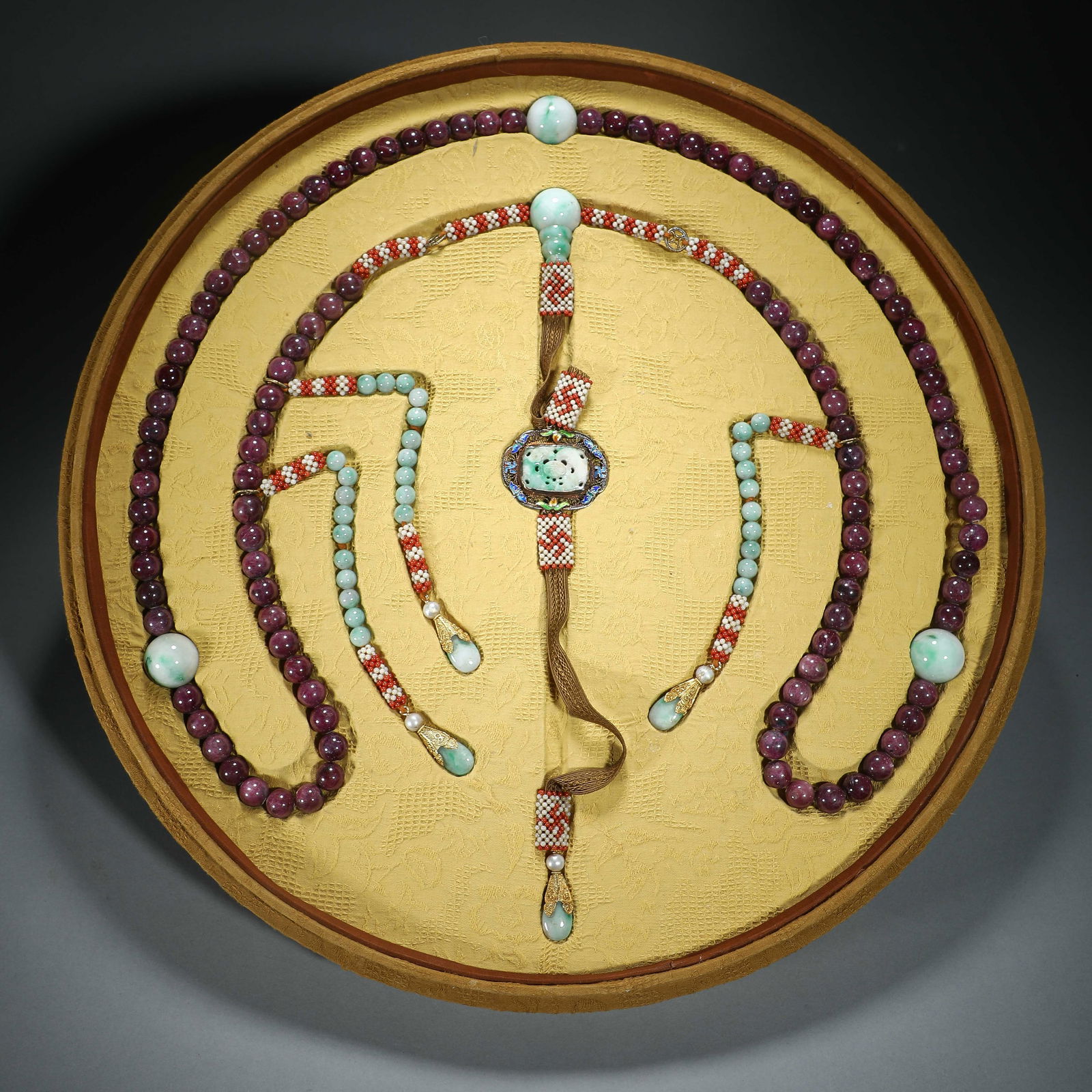 A CHINESE IMPERIAL RUBY ROSARY CHAOZHU: A CHINESE IMPERIAL RUBY ROSARY CHAOZHU The necklace is comprised of one hundred and eight spherical jadeite beads, spaced by four larger fotou jadeite like beads. A double gourd-form stone fotouta