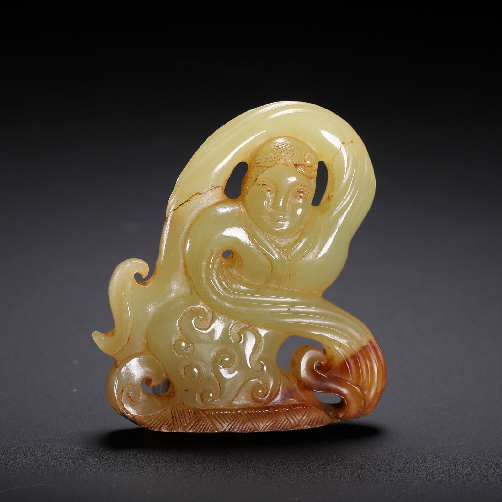 A CHINESE ARCHAISTIC CARVED JADE DANCER (1 of 9)