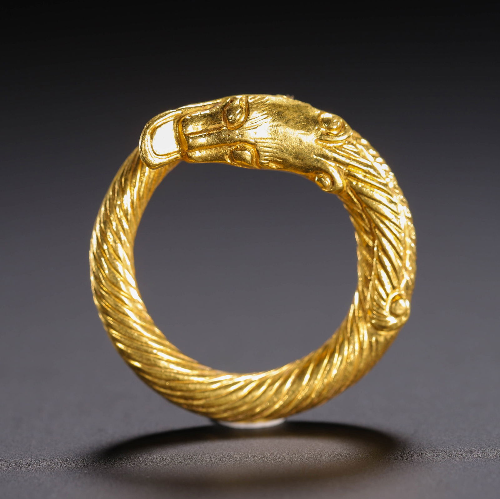 A GOLD CHILONG RING: A GOLD CHILONG RING Casted in dragon form. Dimension: L. 2.7 cm. W. 2.7 cm. H. 2.7 cm. Weight 10 grams.