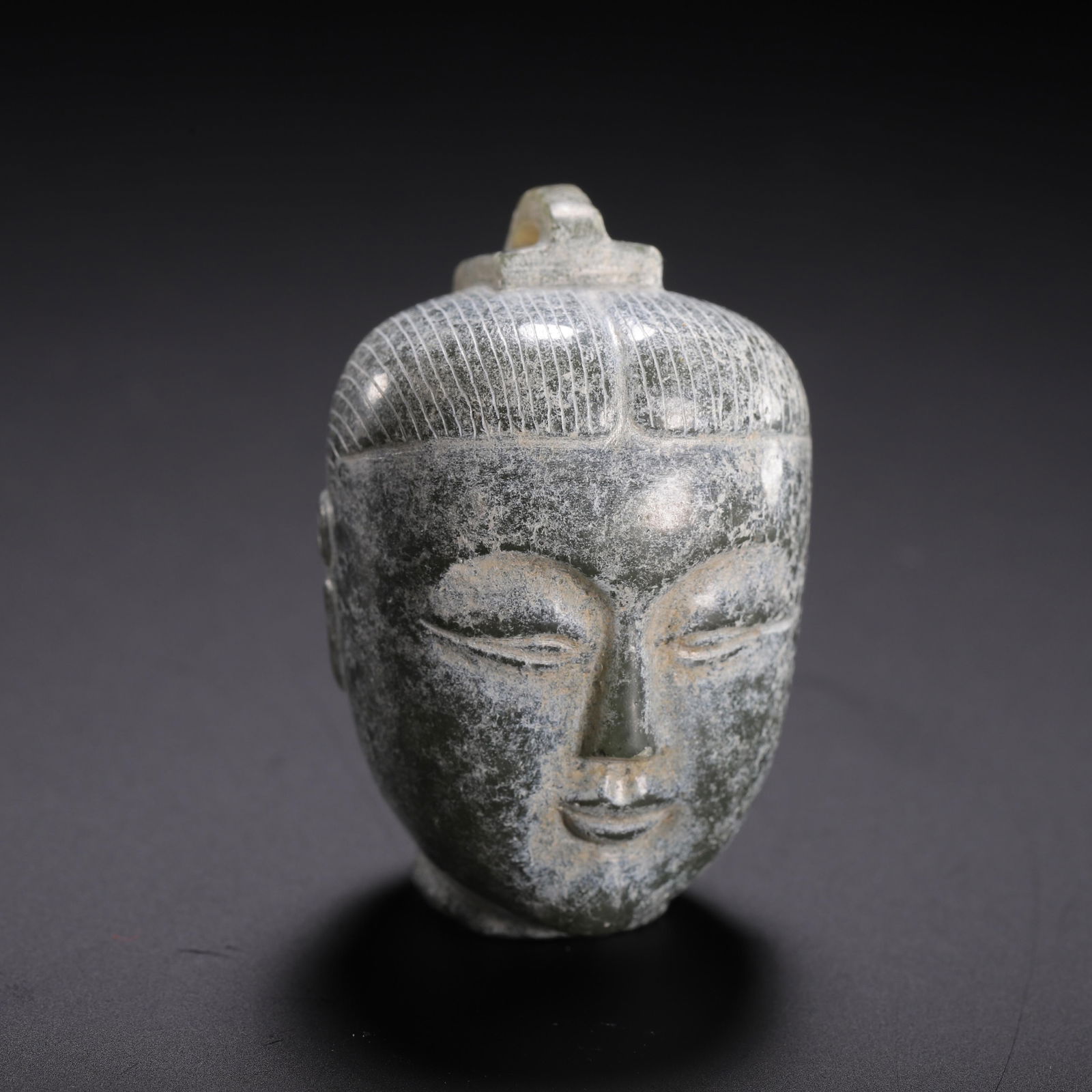 A CARVED JADE HEAD OF FIGURE (1 of 9)