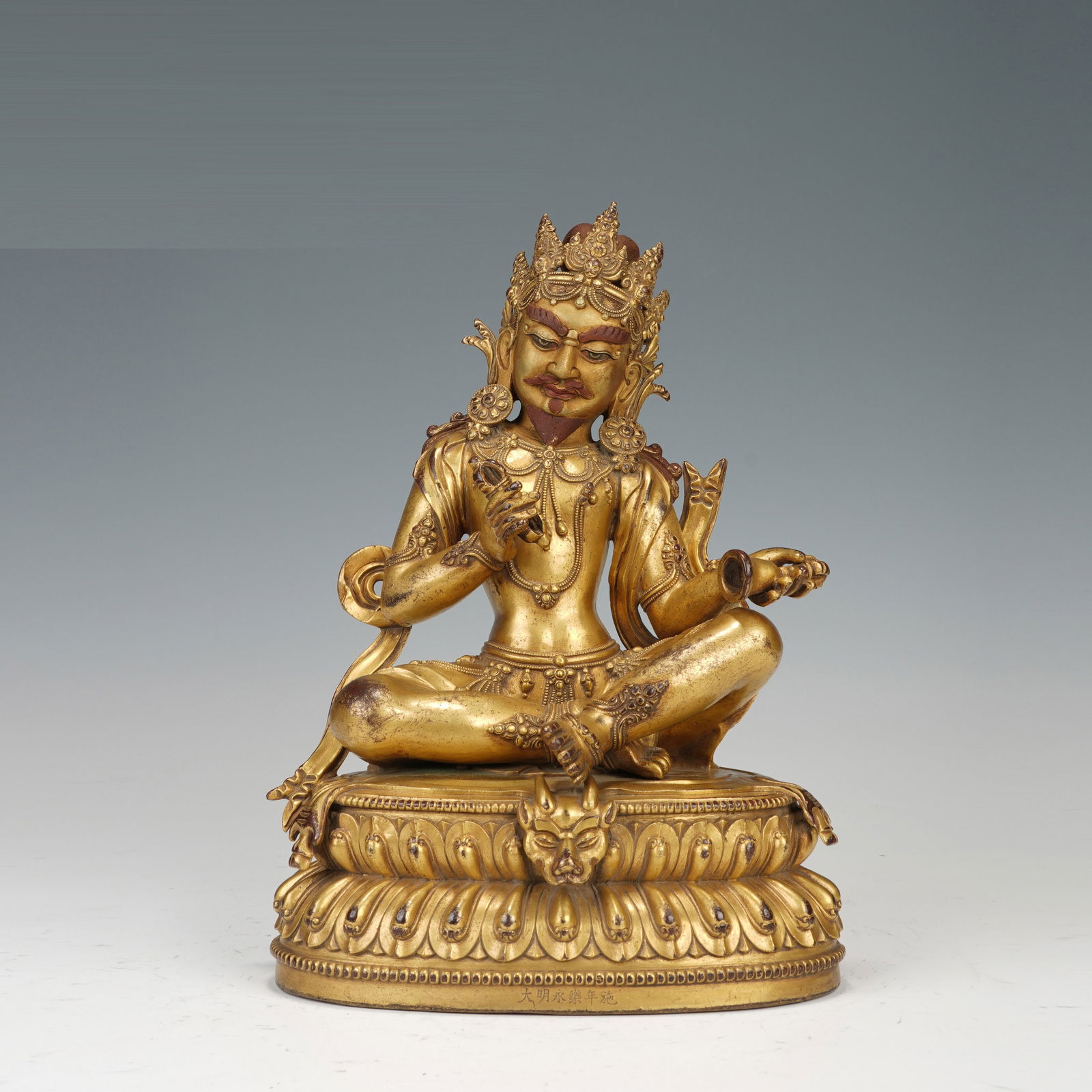 A BRONZE-GILT SEATED DEITY (1 of 10)