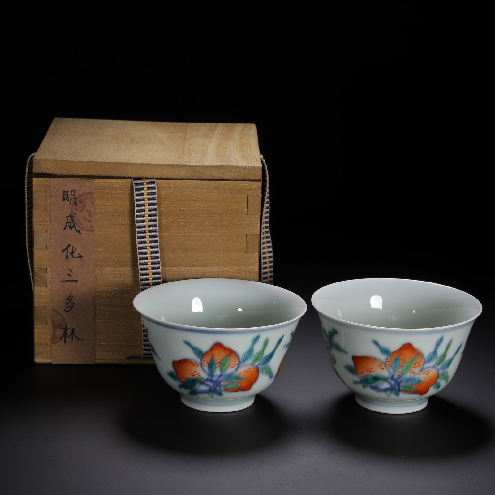 PAIR DOUCAI GLAZE PEACHES CUPS: PAIR DOUCAI GLAZE PEACHES CUPS Each deep rounded sides rising from a slightly tapered foot to an everted rim, decorated with peaches at the exterior. Dimension: L. 8.8 cm. W. 8.5 cm. H. 5.2 cm. Weight