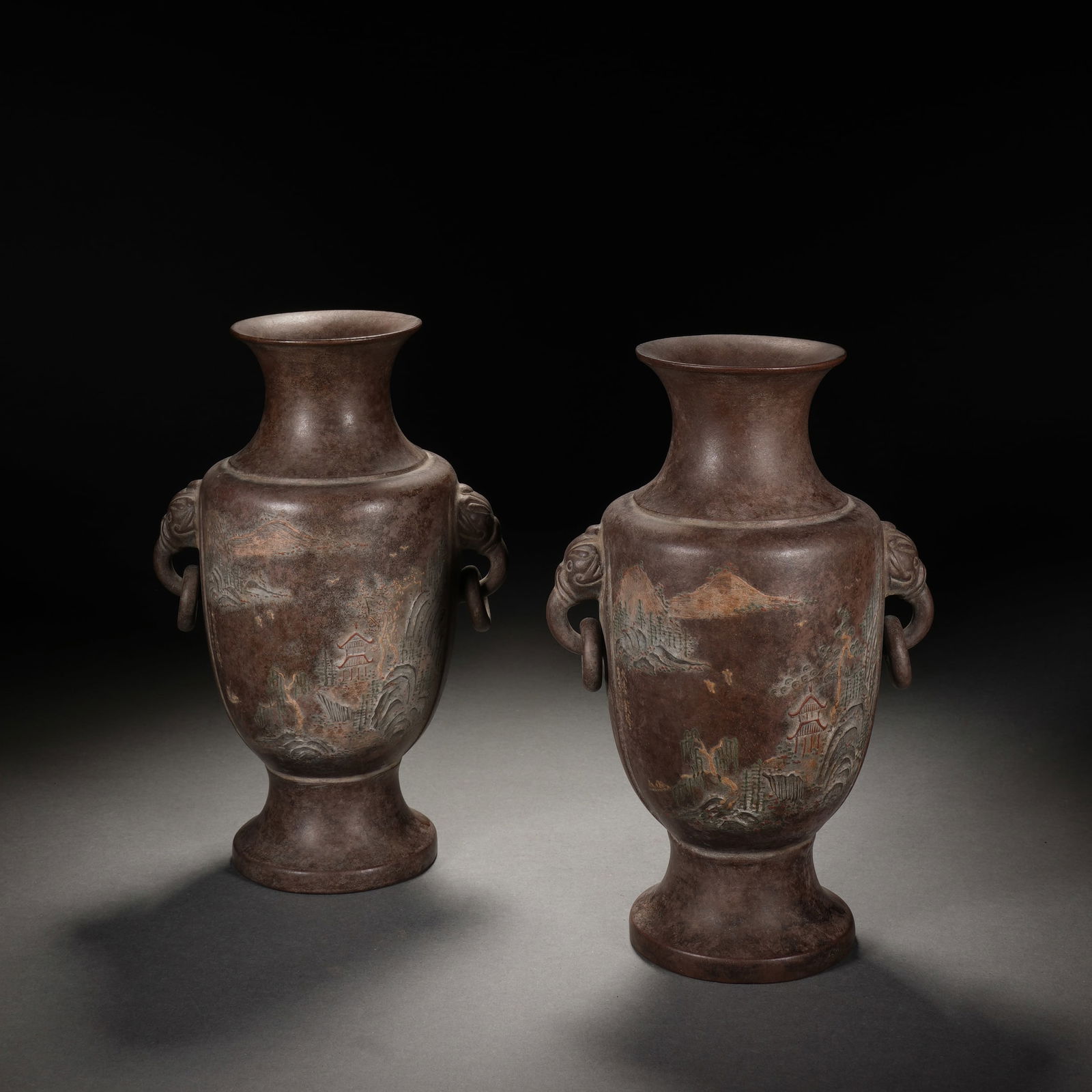 PAIR YIXING GLAZE ZISHA LANDSCAPE VESSELS: PAIR YIXING GLAZE ZISHA LANDSCAPE VESSELS Each of baluster shape, carved landscape at the exterior. Dimension: 12x8.5x18.5 cm.