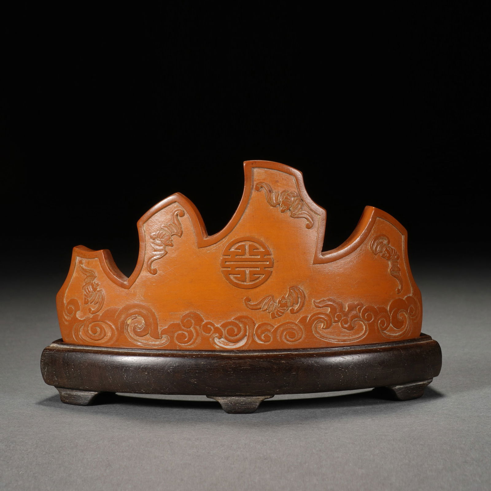 A CARVED BAMBOO BRUSHREST: A CARVED BAMBOO BRUSHREST Decorated with auspicious symbols at the exterior in low relief. Dimension: 12x2.5x7.5 cm.