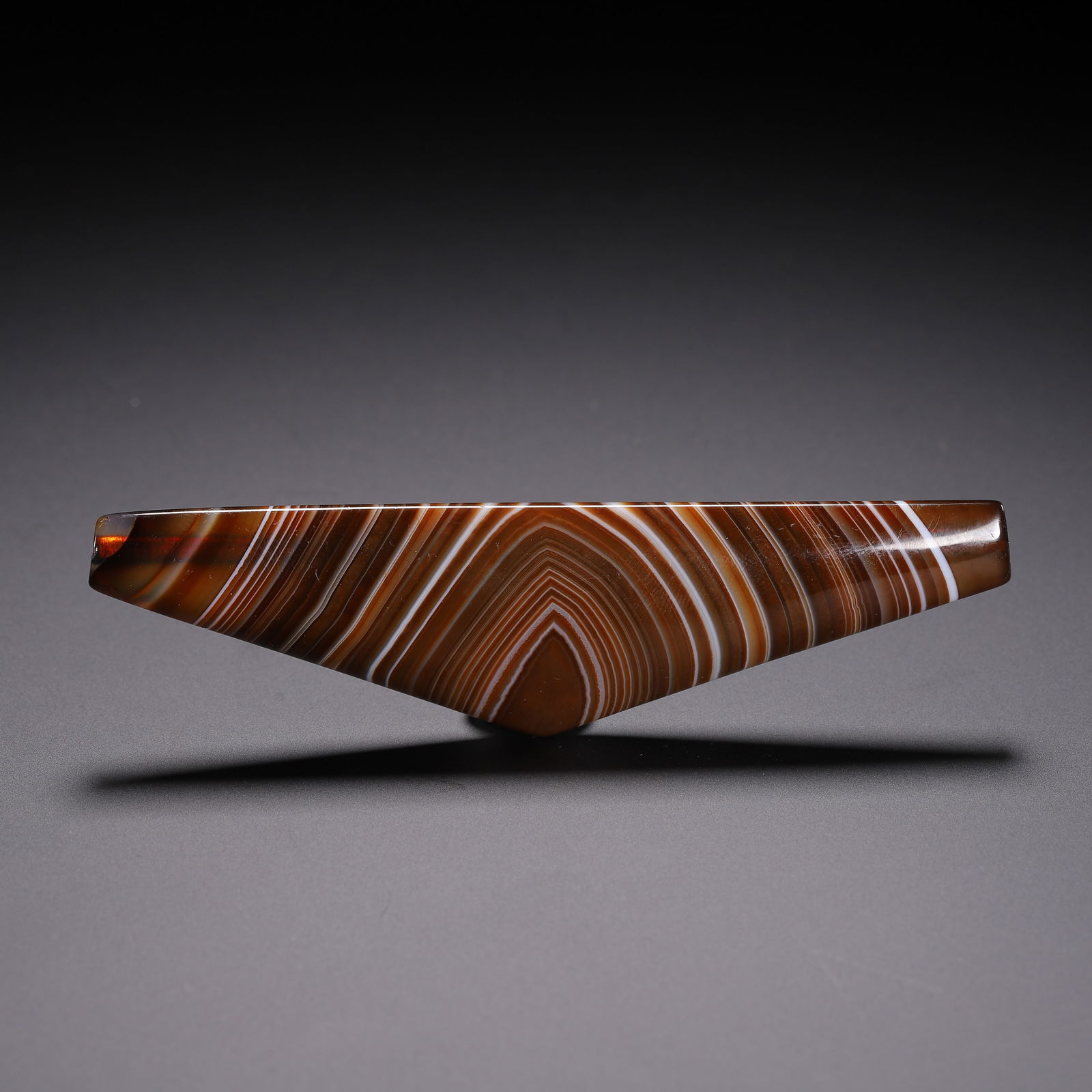 A TIBETAN DZI BEAD: A TIBETAN DZI BEAD With natural color bands. Dimension: L. 10.6 cm. W. 2.63 cm. T. 1.11 cm.