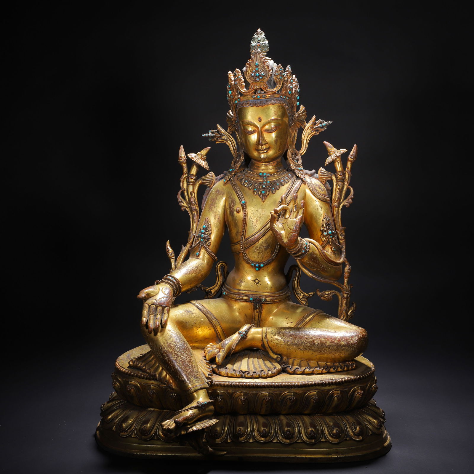 A BRONZE-GILT GREEN TARA: A BRONZE-GILT GREEN TARA Regarded as the female boddhisatva, Tara is one of the most widely worshipped female figures of Buddhism - a savior-goddess who is revered for the protection and guidance she