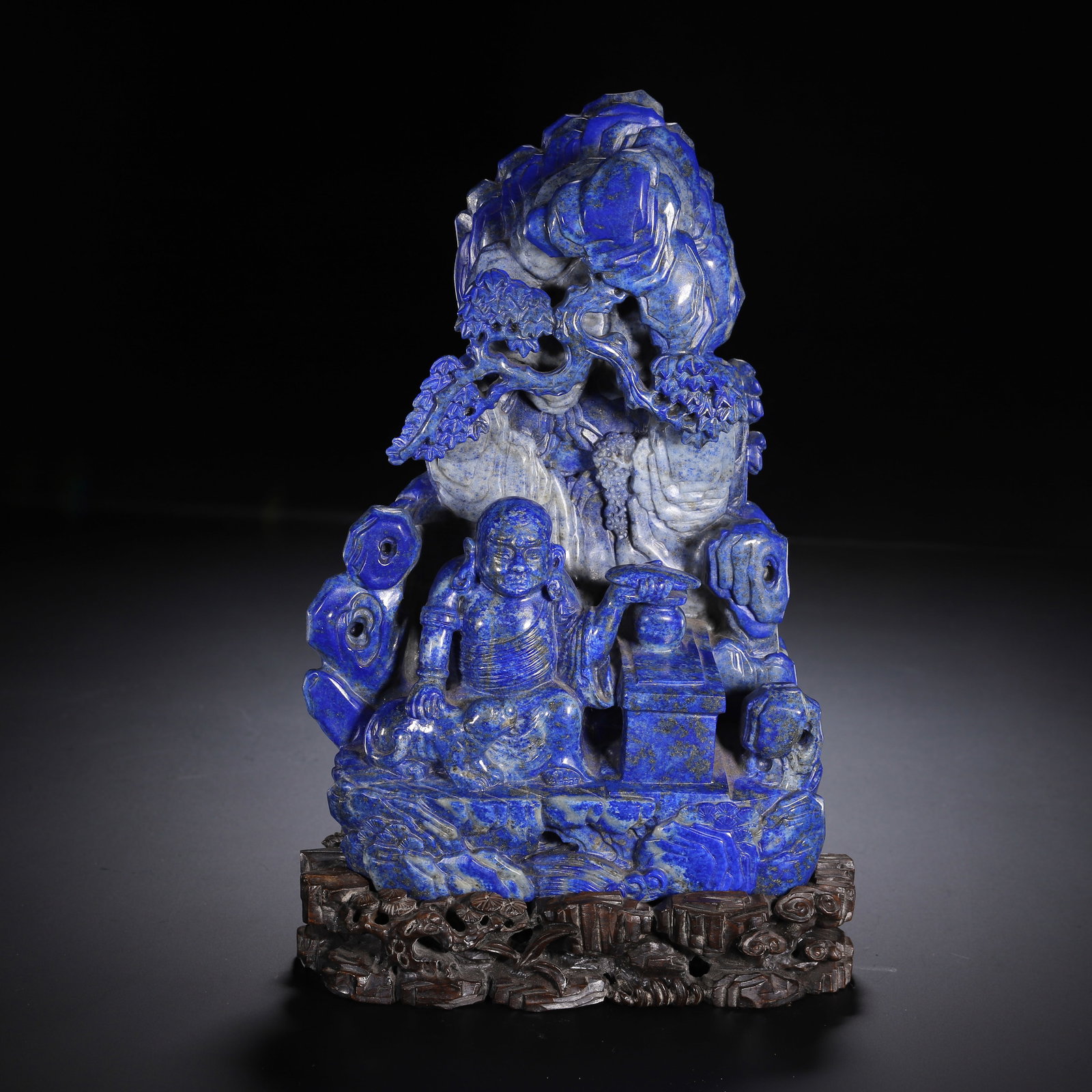 CHINESE LAPIS LAZULI LUOHAN BOULDER CARVING: CHINESE LAPIS LAZULI LUOHAN BOULDER CARVING A Chinese lapis lazuli boulder carving of Luohan, measuring 14 cm in length and 23.5 cm in height. Carved from a single block of deep royal-blue lapis lazul