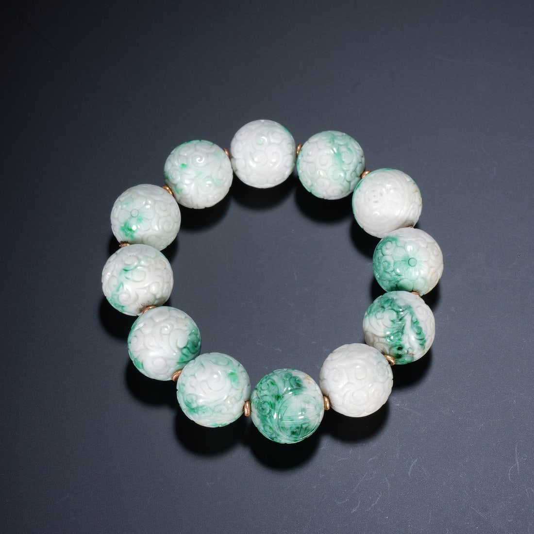 A CHINESE CARVED JADEITE BEAD BRACELET (1 of 6)