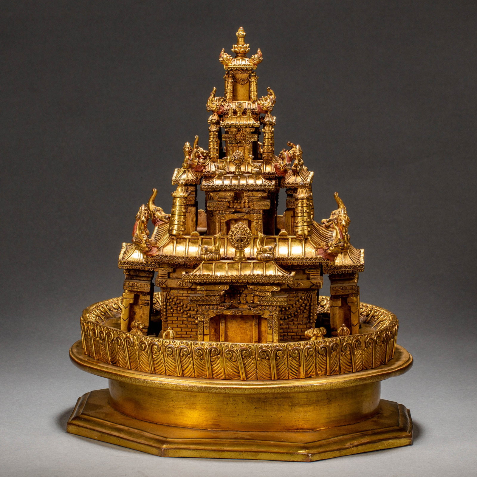 Chinese Gilt-Bronze Buddhist Mandala Altar: Chinese Gilt-Bronze Buddhist Mandala Altar An exquisitely detailed mandala altar cast in gilt bronze, representing a multi-tiered celestial palace with ornate spires, guardian figures, and intricate a