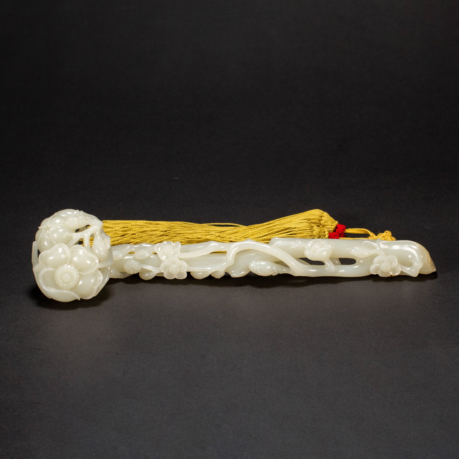 Chinese Hetian Jade Ruyi Scepter: Chinese Hetian Jade Ruyi Scepter A finely carved Hetian jade ruyi scepter, rendered in smooth, lustrous pale white stone. The terminal head is intricately carved in openwork with blossoming flowers, w