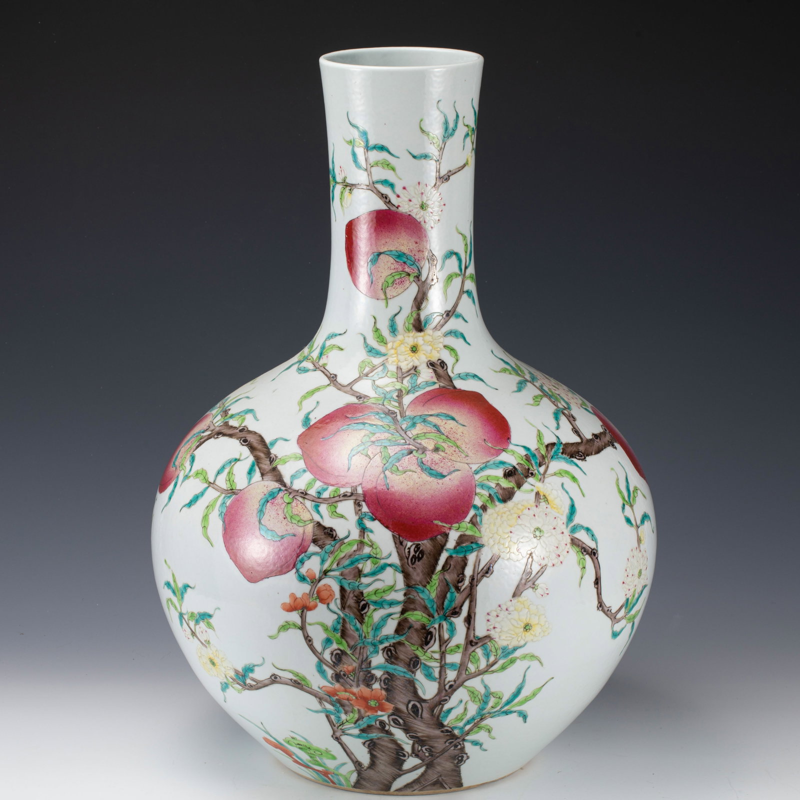 A CHINESE FAMILLE ROSE PEACHES GLOBULAR VASE: A CHINESE FAMILLE ROSE PEACHES GLOBULAR VASE Raising from a circular foot to a straight neck, the globular body finely painted with peach branches in famille rose glaze. Dimension: L. 15 cm. H. 11