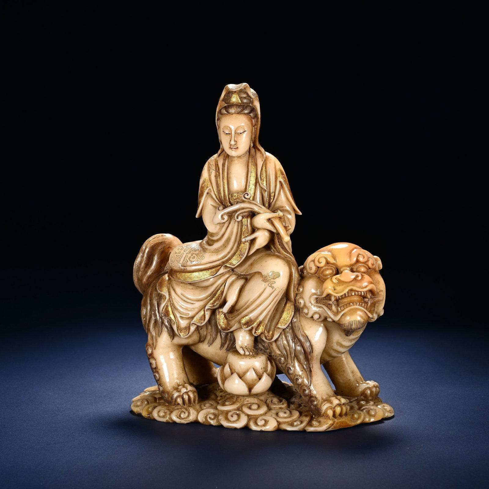 Chinese Shoushan Stone Carved Manjushri Statue: Chinese Shoushan Stone Carved Manjushri Statue This exquisite Shoushan stone carving of Manjushri measures 17 cm in height and 13 cm in width. The bodhisattva is depicted seated serenely atop a guardi