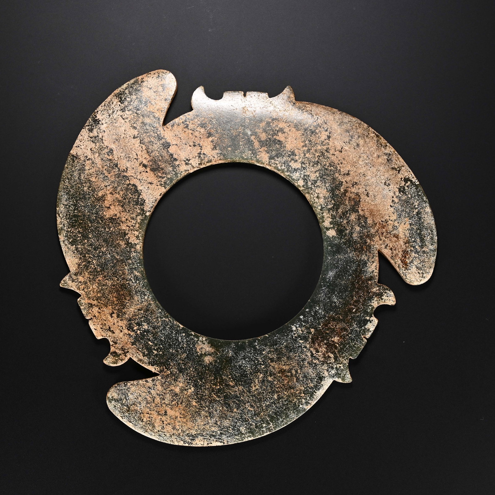 Chinese Hetian Jade Xuanji Disc: Chinese Hetian Jade Xuanji Disc A Chinese Hetian jade xuanji disc, circular in form with a central aperture and three evenly spaced raised projections around its outer rim. The stone displays a weathe