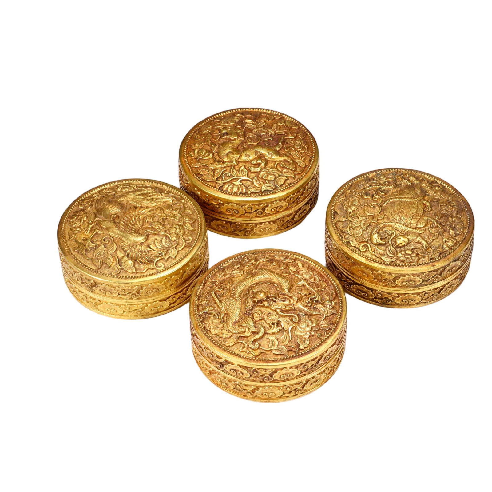 Set of Four Chinese Gilt Bronze 'Four Auspicious Beasts' Circular Boxes: Set of Four Chinese Gilt Bronze 'Four Auspicious Beasts' Circular Boxes This exquisite set of four gilt bronze circular boxes measures 3.5 cm in height and 8.5 cm in width each. Each box lid is emboss