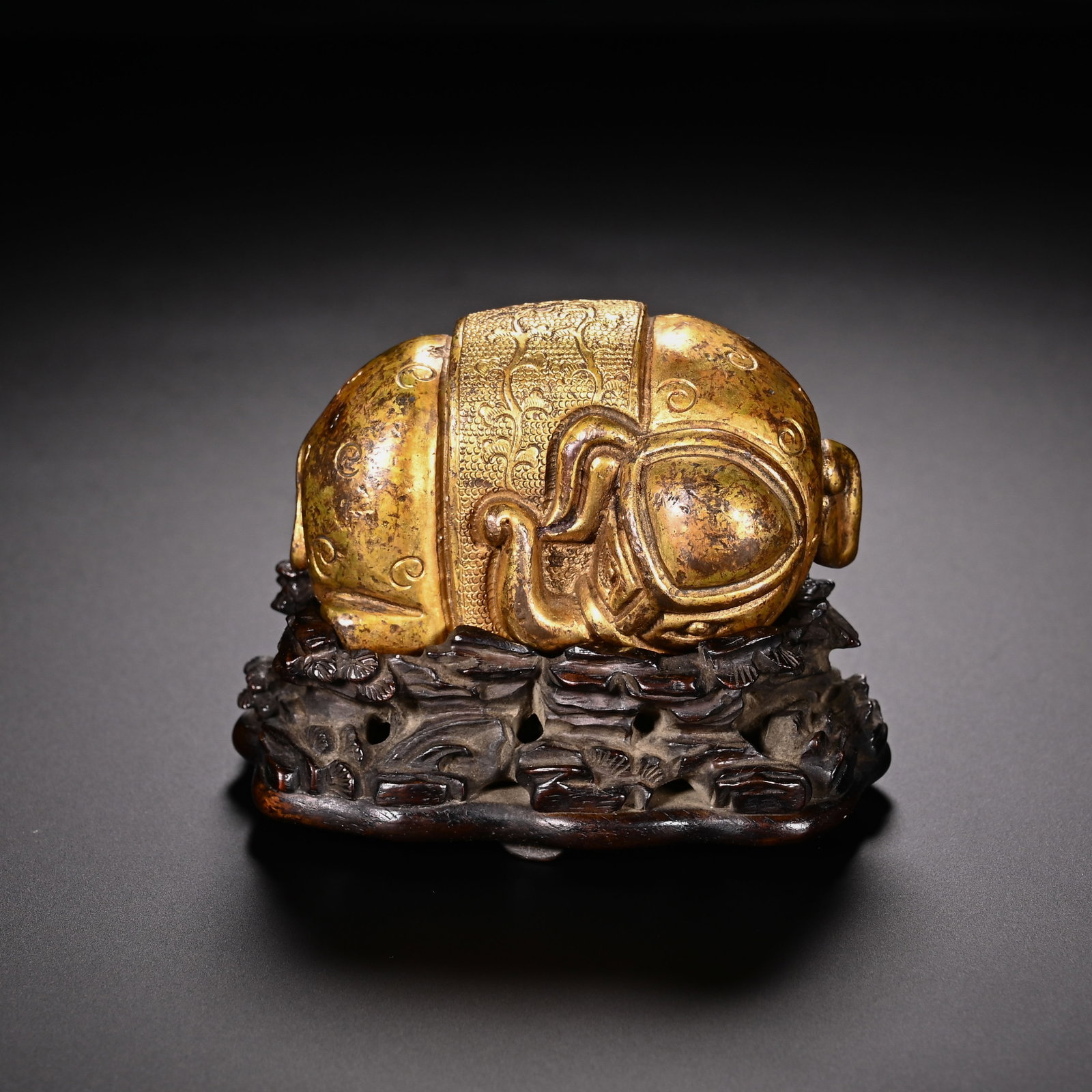 Chinese Gilt Bronze Elephant Ornament with Stand: Chinese Gilt Bronze Elephant Ornament with Stand This charming gilt bronze elephant ornament measures 5.5 cm in height and 6.5 cm in width. The elephant is depicted in a relaxed, recumbent pose, its
