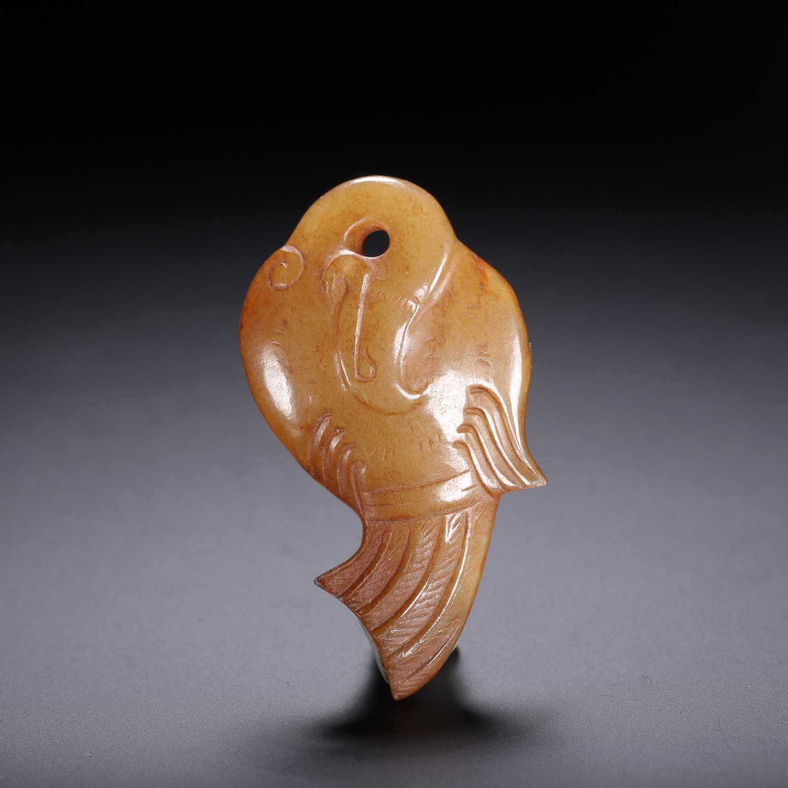 Chinese Archaic Jade Bird Pendant: Chinese Archaic Jade Bird Pendant This is a fine Chinese archaic jade bird pendant, measuring 5.5 cm in length, 3 cm in width, and weighing 20 grams. The stylized bird is carved from a warm, honey-ton
