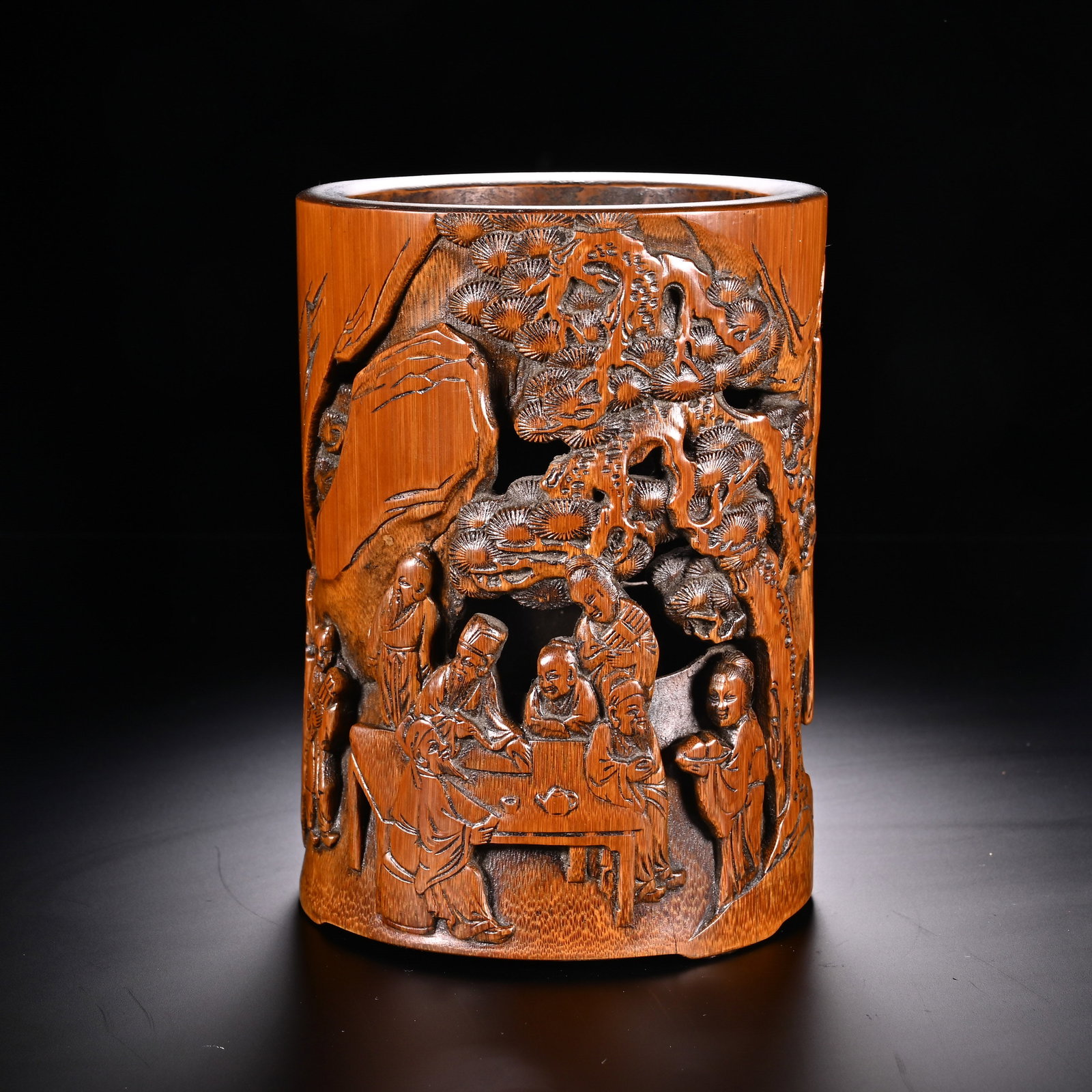 Chinese Bamboo Carved Brush Pot with Scholar Gathering Scene: Chinese Bamboo Carved Brush Pot with Scholar Gathering Scene This cylindrical bamboo brush pot measures 14.3 cm in height and 10.7 cm in width. The exterior features an elaborate openwork and relief c
