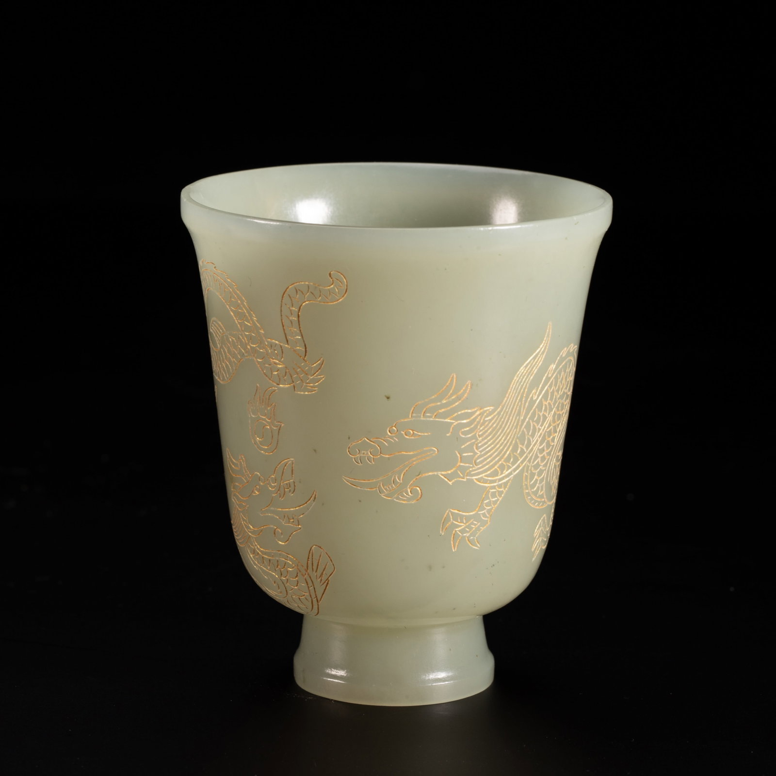 Chinese Hetian Jade Cup with Gilt Dragon Decoration: Chinese Hetian Jade Cup with Gilt Dragon Decoration This is an elegant Chinese Hetian jade wine cup, measuring 6.5 cm in diameter, 7.5 cm in height, and weighing 100 grams. The vessel is carved from a