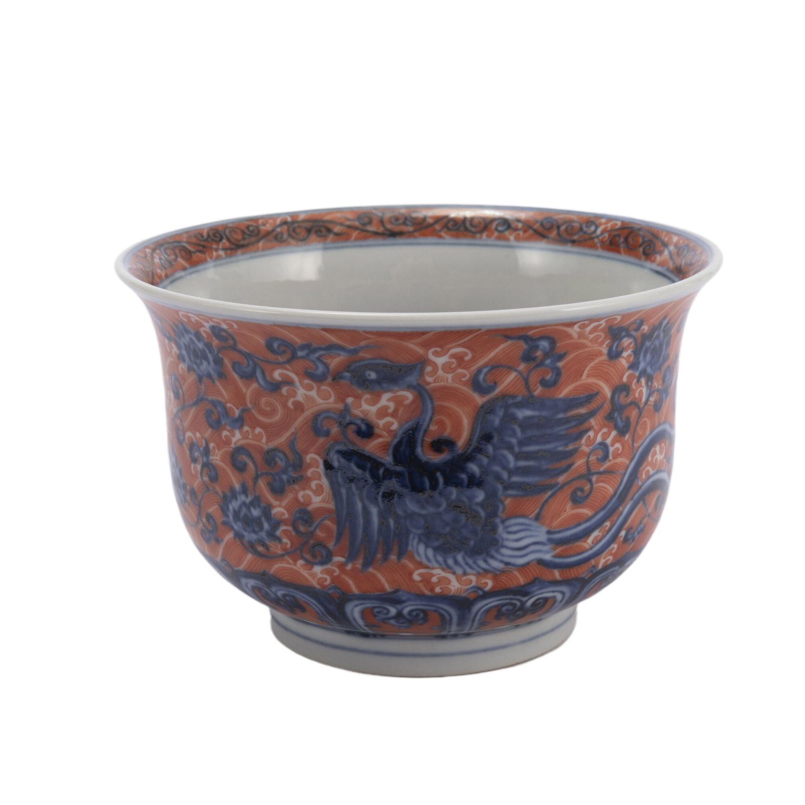 AN UNDERGLAZE BLUE AND IRON RED PORCELAIN BOWL: AN UNDERGLAZE BLUE AND IRON RED PORCELAIN BOWL The deep rounded sides rising from a slightly tapered foot, painted flying phoenix among floral scrolls. Dimension: L. 9.8 cm. H. 9.8 cm. H. 22 cm. Weigh