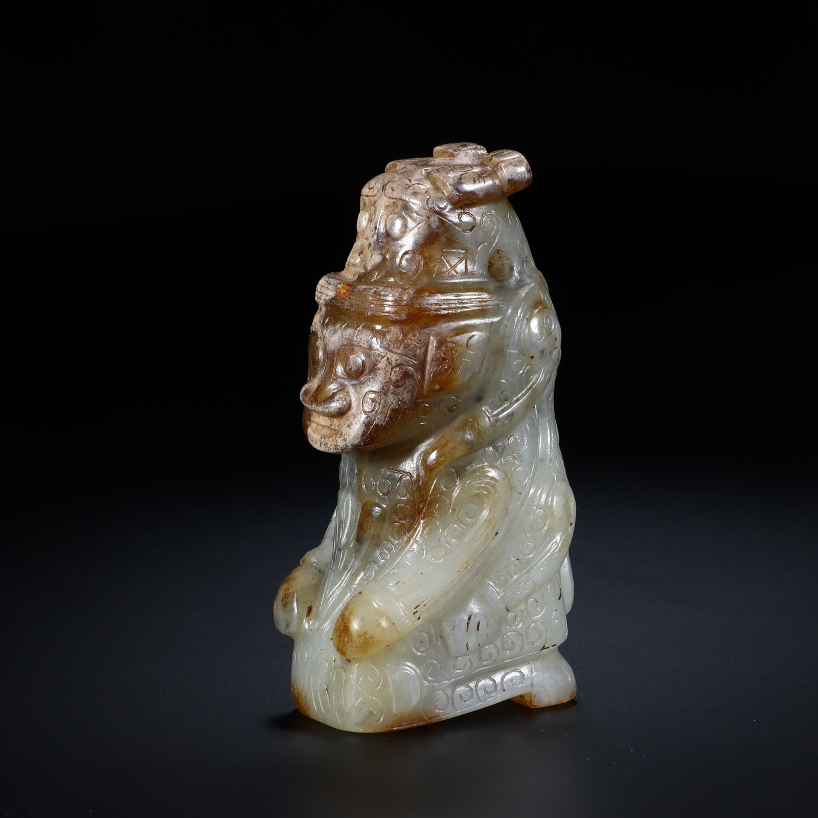 Chinese Archaistic Jade Kneeling Figure (Yu Gui Ren): Chinese Archaistic Jade Kneeling Figure (Yu Gui Ren) This finely carved archaistic jade kneeling figure measures 8.2 cm in height and 3.9 cm in width. The pale celadon jade is accented by natural russ