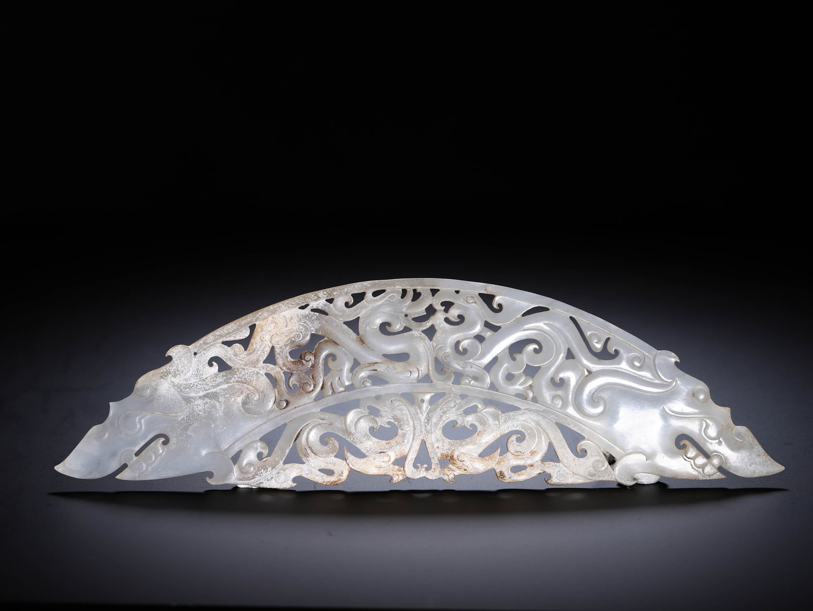 Chinese Archaic Openwork Jade Huang Pendant: Chinese Archaic Openwork Jade Huang Pendant This is a fine Chinese archaic openwork jade huang pendant, measuring 27 cm in length, 7.5 cm in width, and weighing 110 grams. The semi-circular jade is ca