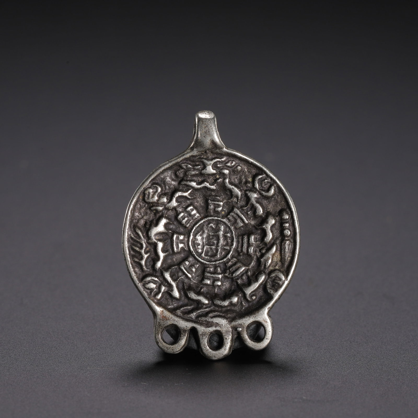 Chinese Tibetan Bronze Bagua Amulet Pendant: Chinese Tibetan Bronze Bagua Amulet Pendant A small, intricately cast Tibetan amulet pendant, featuring the traditional Bagua (Nine Palaces) design. The silver-toned bronze surface displays detailed r