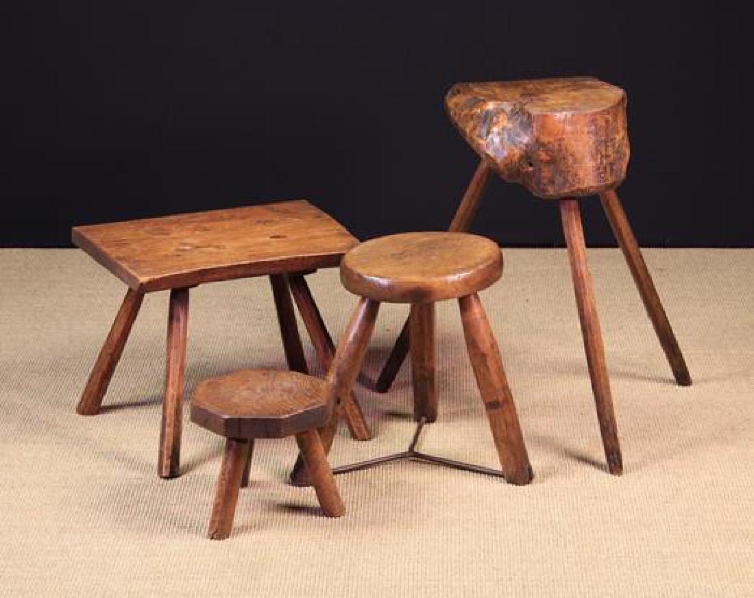 A Rustic Chopping Block & Three Stools. The chopping: A Rustic Chopping Block & Three Stools. The chopping block composed of a section of burr figured trunk raised on three splayed chamfered legs 25½ in (64 cm) high, 13 in x 13 in (33 cm x 33 cm). A rec