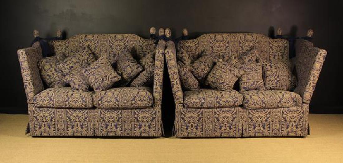 A Pair of Knowle Settees covered in a cream & blue: A Pair of Knowle Settees covered in a cream & blue woven fabric; the hinged sides and back secured by tasselled cord tied around covered finial posts to the corners, 45 ins (115 cm) high, approx. 29 i