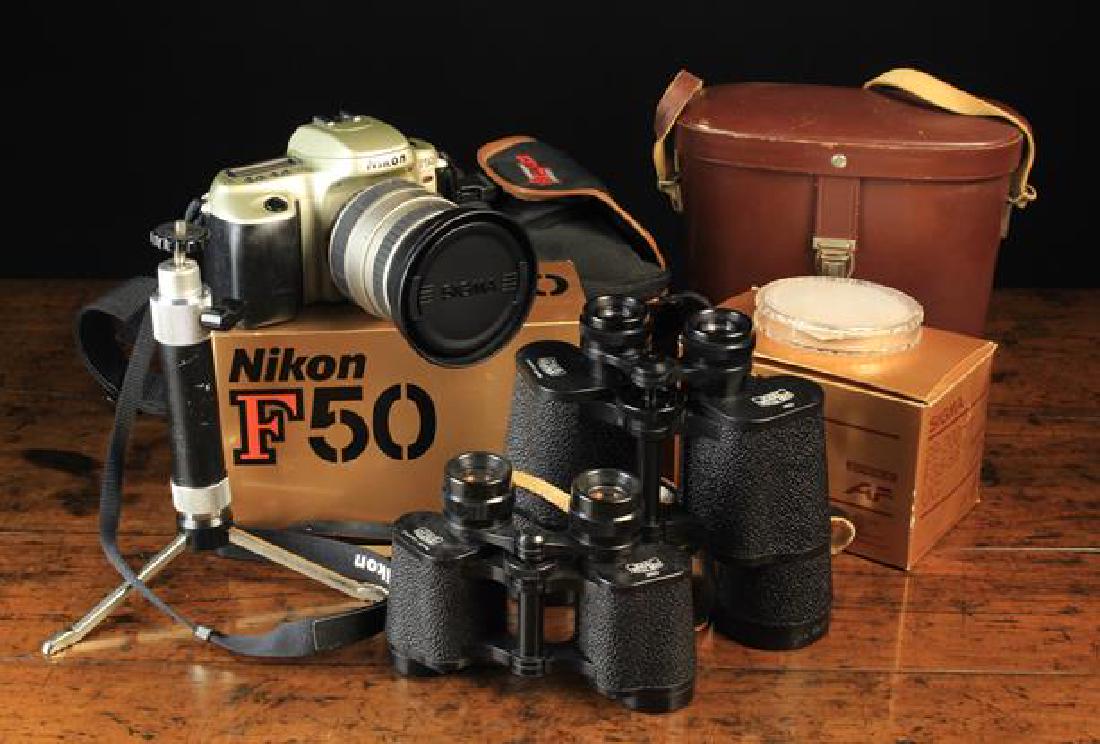 A Nikon F50 35 mil Camera with Sigma 28-200 mm lens, a: A Nikon F50 35 mil Camera with Sigma 28-200 mm lens, a Jessop's table tripod, and two pairs of Carl Zeiss Jena Binoculars one 10 x 50, the other 8 x 30.