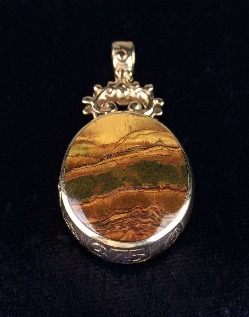 A 9 Carat Yellow Gold Double-sided Fob Pendant by David: A 9 Carat Yellow Gold Double-sided Fob Pendant by David Scott Walker with assay marks for Sheffield 1988, set with an oval Tiger's eye stone to one side and malachite to the other with scrolling mount