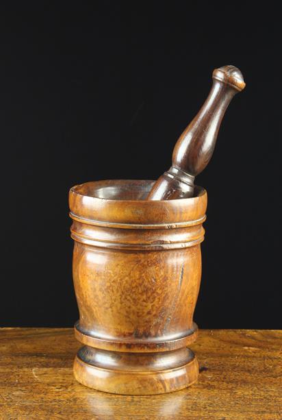 A Good Late 17th/Early 18th Century Lignum Vitae Pestle: A Good Late 17th/Early 18th Century Lignum Vitae Pestle & Mortar with turned foot, fine colour & patination. The pestle 10'' (25 cm) long, the mortar 7'' (18 cm) high, 5'' (12.5 cm) in diameter.