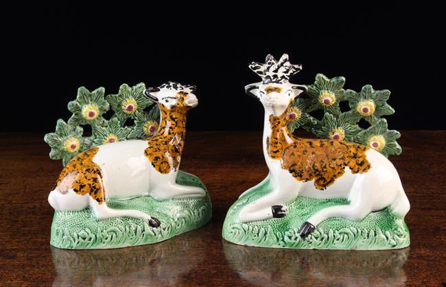 An Early Staffordshire Pearlware Hollow-moulded Roe: An Early Staffordshire Pearlware Hollow-moulded Roe Deer & Stag reclining on grassy clumps with flowering boccage trees to the rear, 6'' (15 cm) high, 5¾'' (14.5 cm) wide.